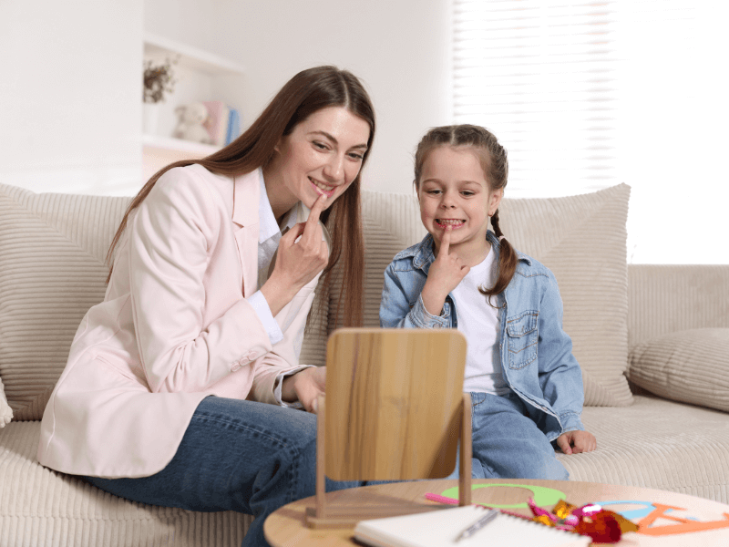 Logopédeus tanítja az s ejtését egy kislánynak.